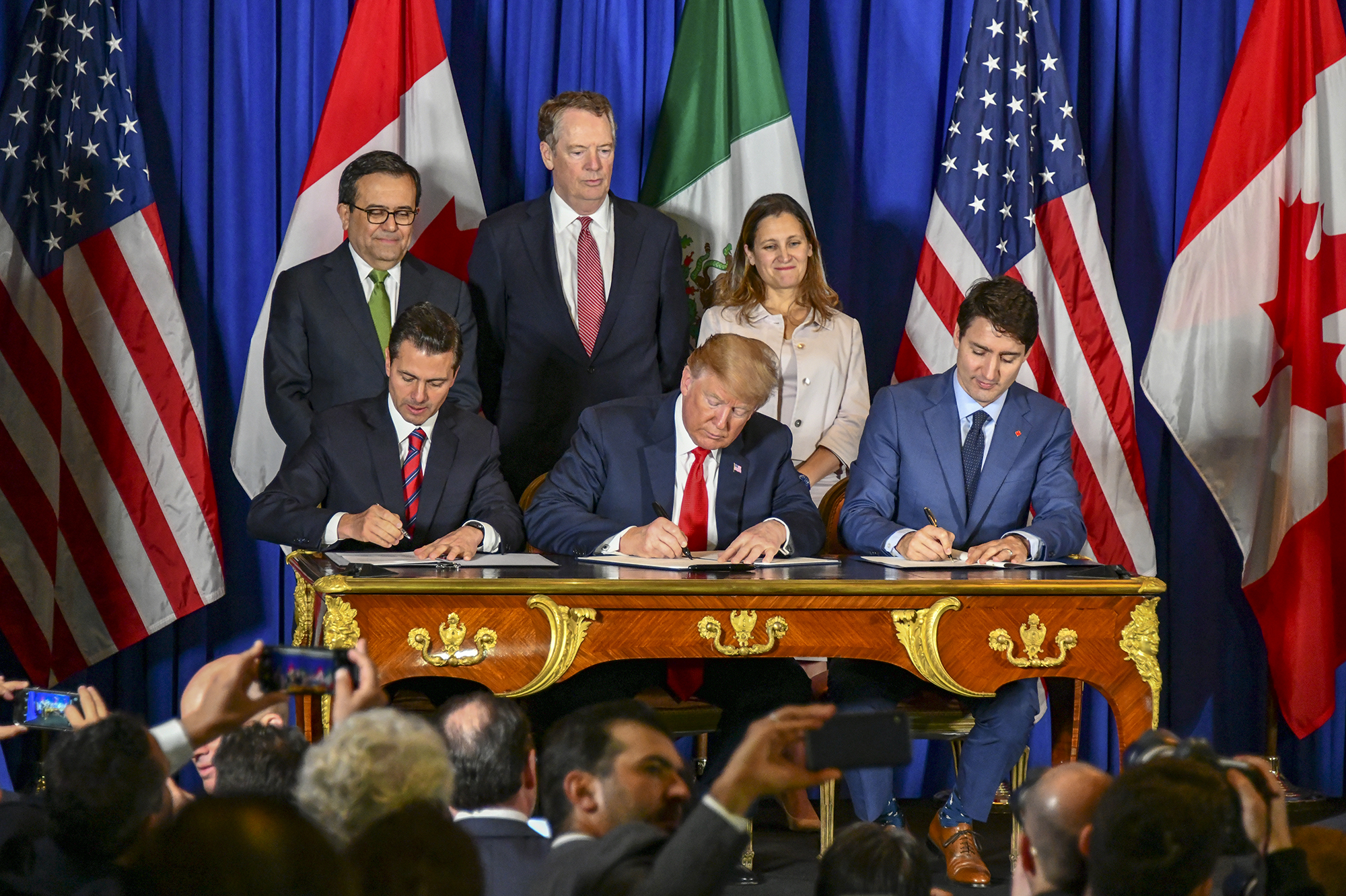Former Mexican President Enrique Peña Nieto, President Donald Trump and Canadian President Justin Trudeau sign the U.S.-Mexico-Canada Agreement during a ceremony in Buenos Aires, around the time of the G-20 Leaders' Summit on Nov. 30, 2018. (Ron Przysucha, U.S. State Department/Public Domain)
